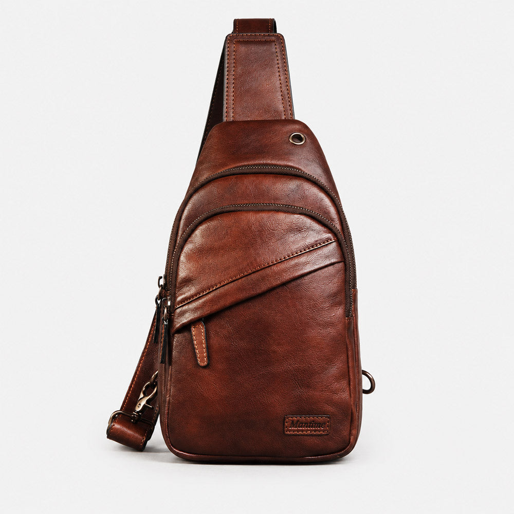 Front view of deep brown leather waist bag with leather logo patch, curved zipper structure, and vintage full-grain finish