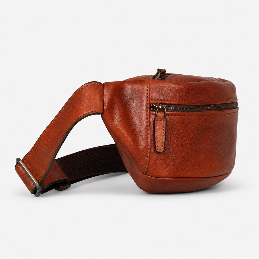 Side view of mens leather waist bag showing compact 10cm depth, curved leather body, and adjustable strap hardware