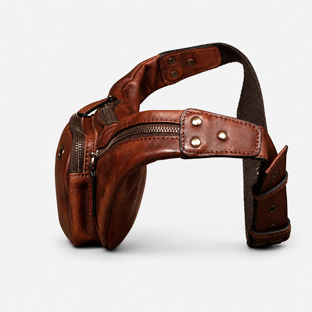 Side profile of leather waist bag showing ultra-slim 5cm depth, curved fanny pack structure, and adjustable carry strap