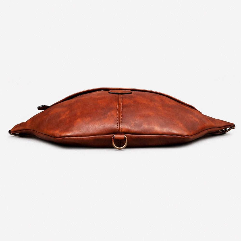 Bottom view of dark brown full-grain leather shoulder bag showing structured base, reinforced seams, and vintage bum bag construction