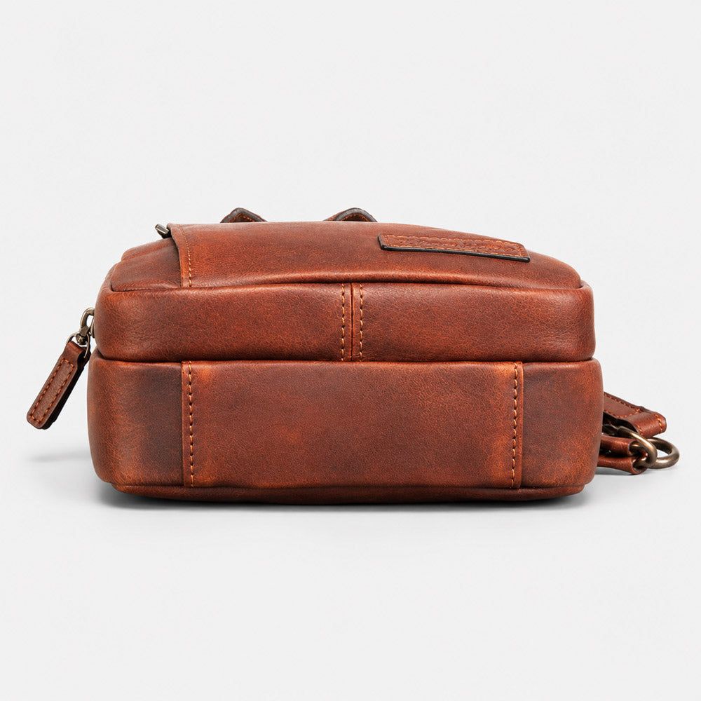 Bottom view of brown full-grain leather waist bag showing structured base, reinforced stitching, and compact 8cm profile