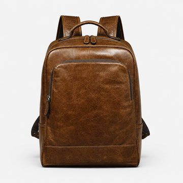 Brown oil-wax leather backpack front view with structured zip pocket