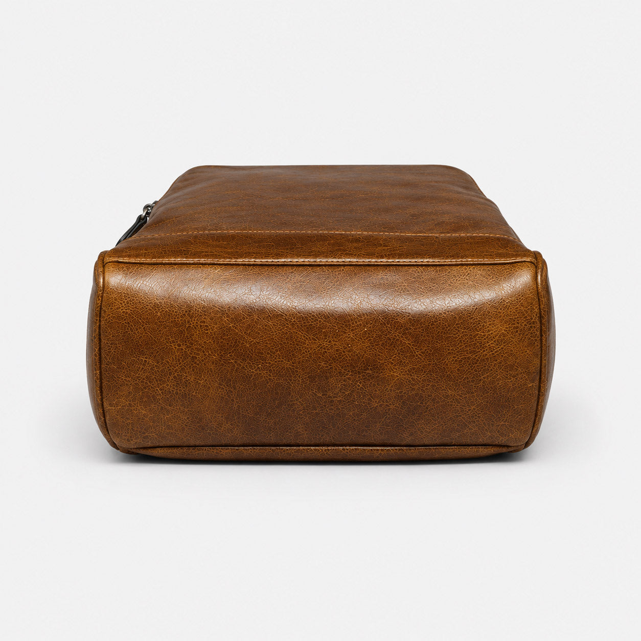 Reinforced leather base panel of the commuter backpack