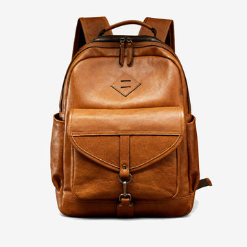 Light brown vegetable-tanned leather backpack front view with buckled flap pocket