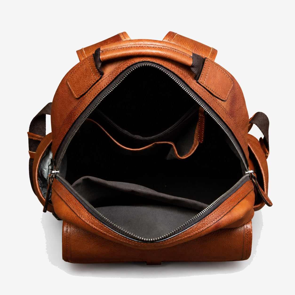 Leather backpack opened to show the main compartment and interior divider