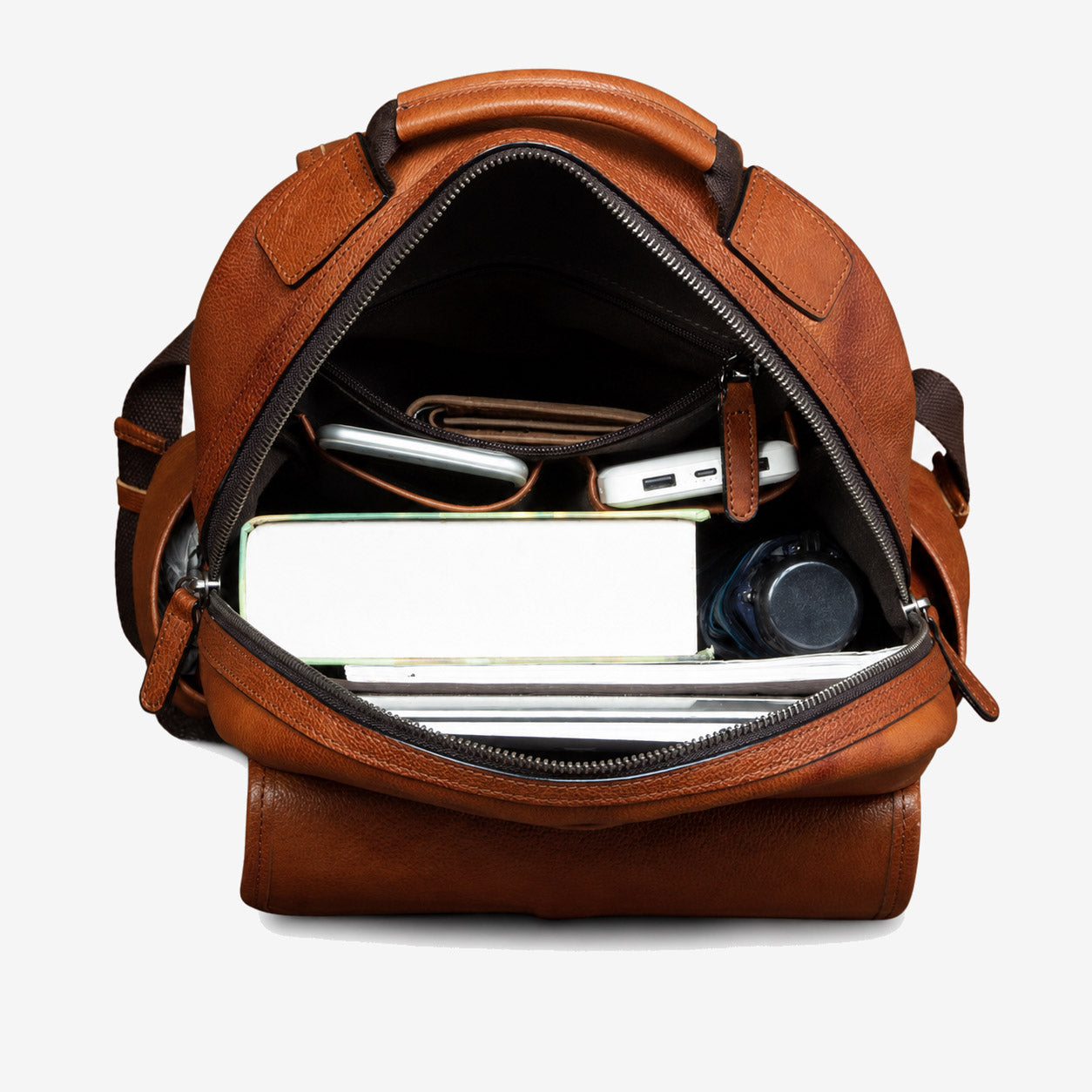 Leather backpack packed with a 15-inch laptop, notebook, wallet, phone and water bottle