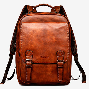 Hand-burnished brown leather backpack front view with twin buckled flap straps