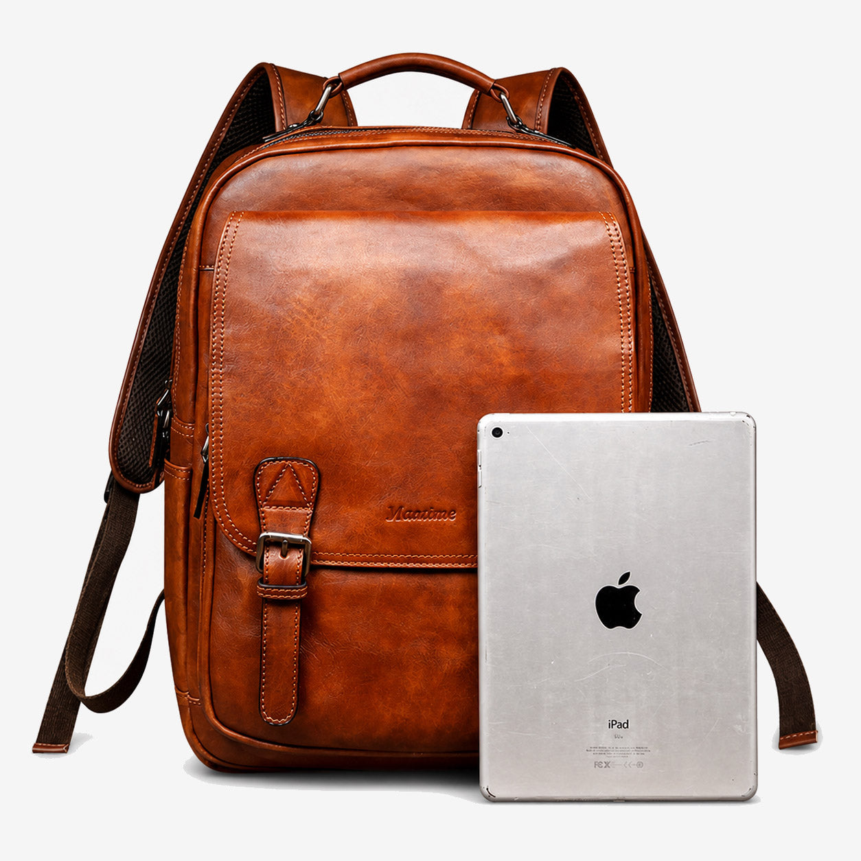 Large leather backpack shown beside a tablet as a size reference